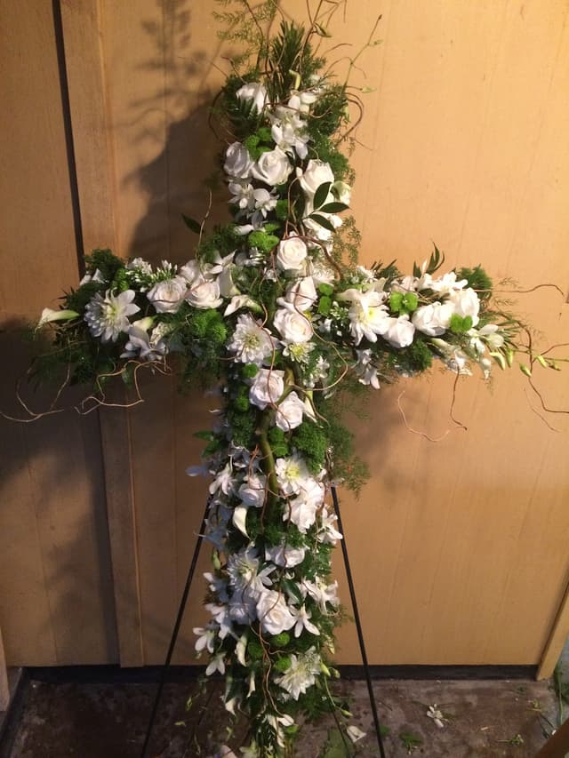 Sympathy standing cross of white flowers with delicate accents