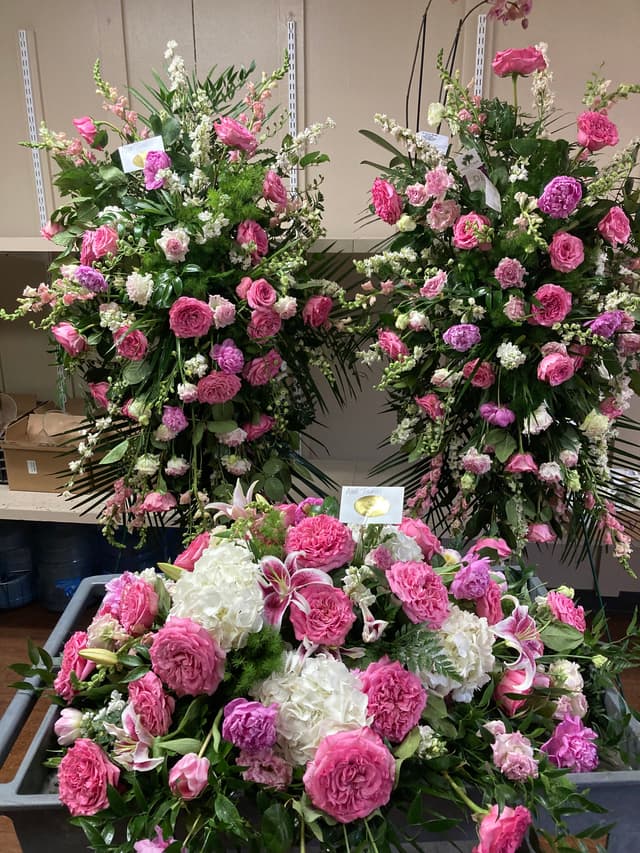 Matching standing spray and casket piece in pink and white