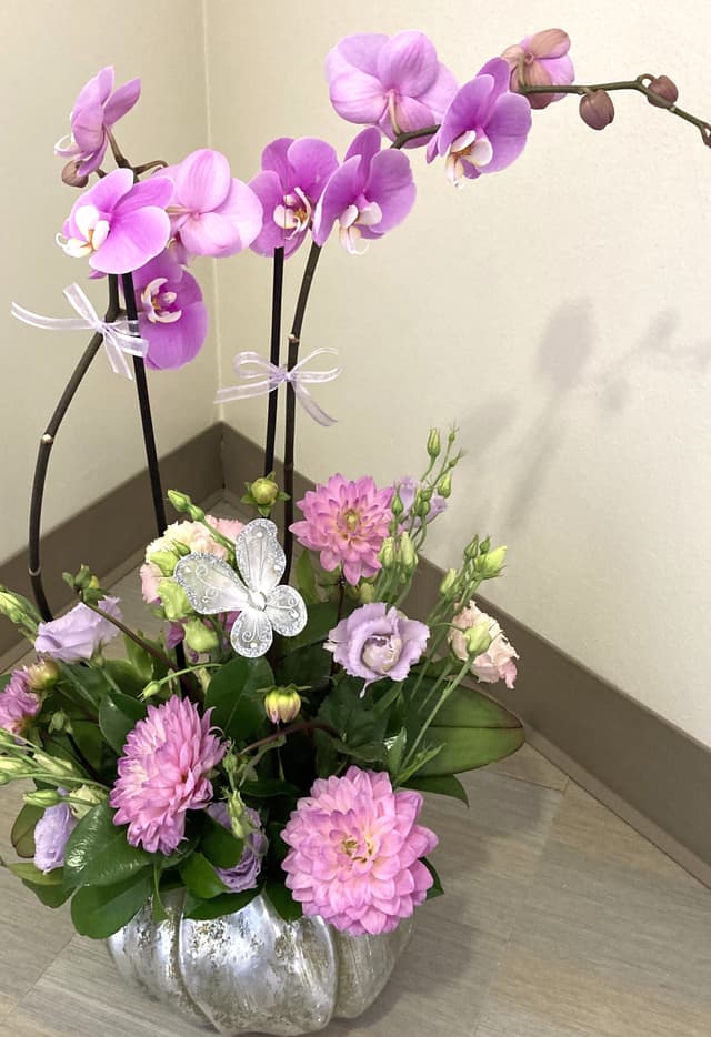 Silver planter with pink phalaenopsis orchids, dahlias, and butterfly accents