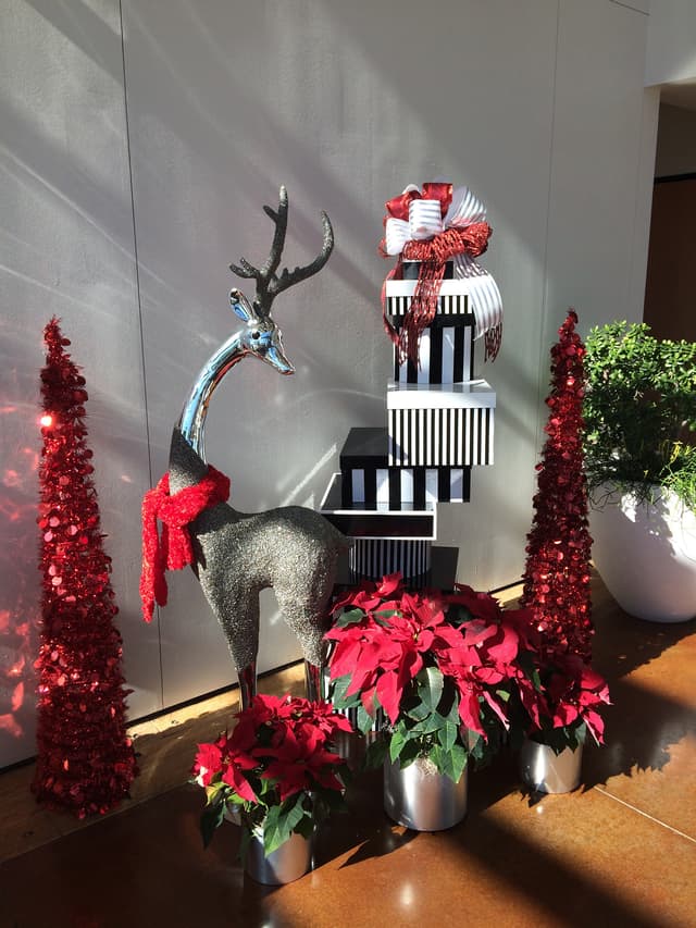 Contemporary red Christmas display with a sequined reindeer for an office lobby