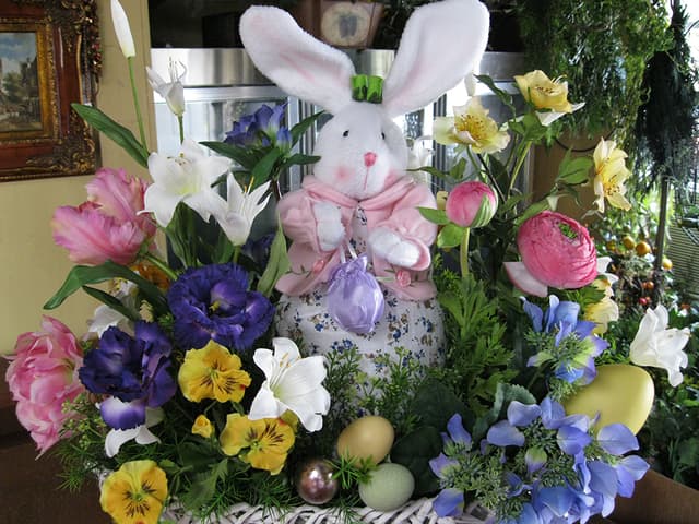 Whimsical Easter garden scene with a plush bunny among spring flowers