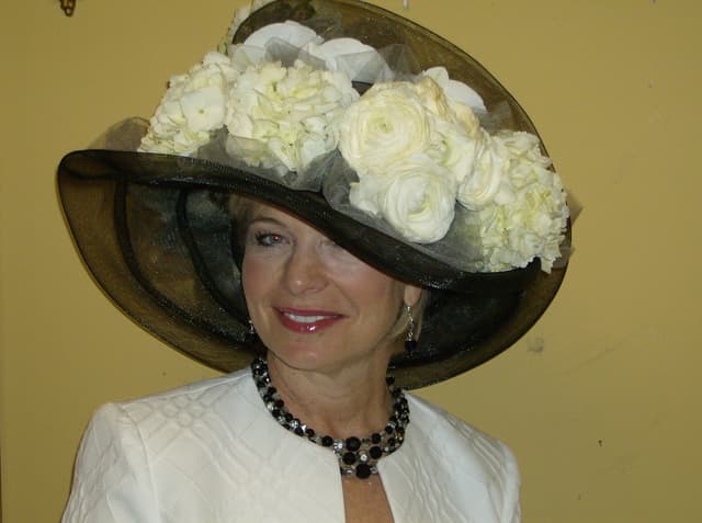 Derby hat trimmed with white hydrangea blooms