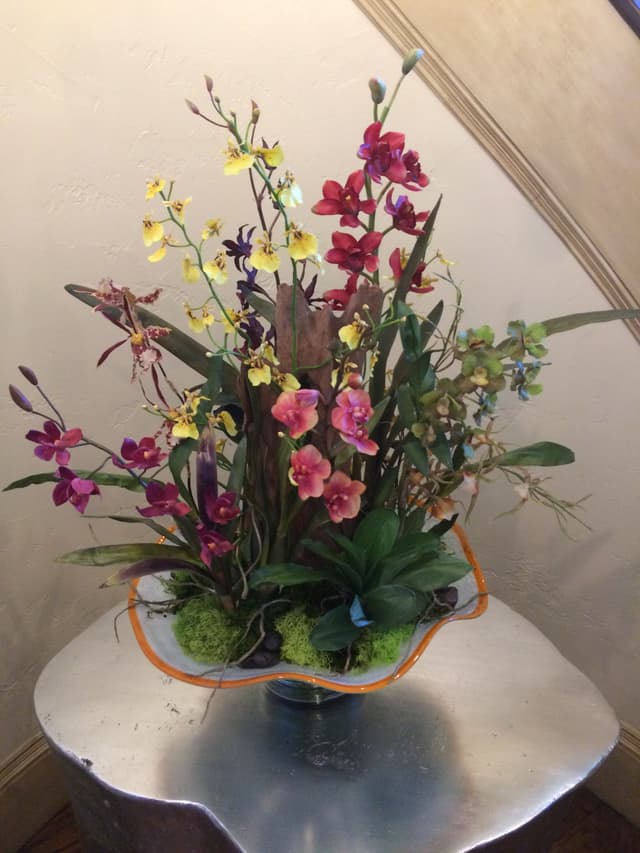 Modern silk orchid design set in green moss