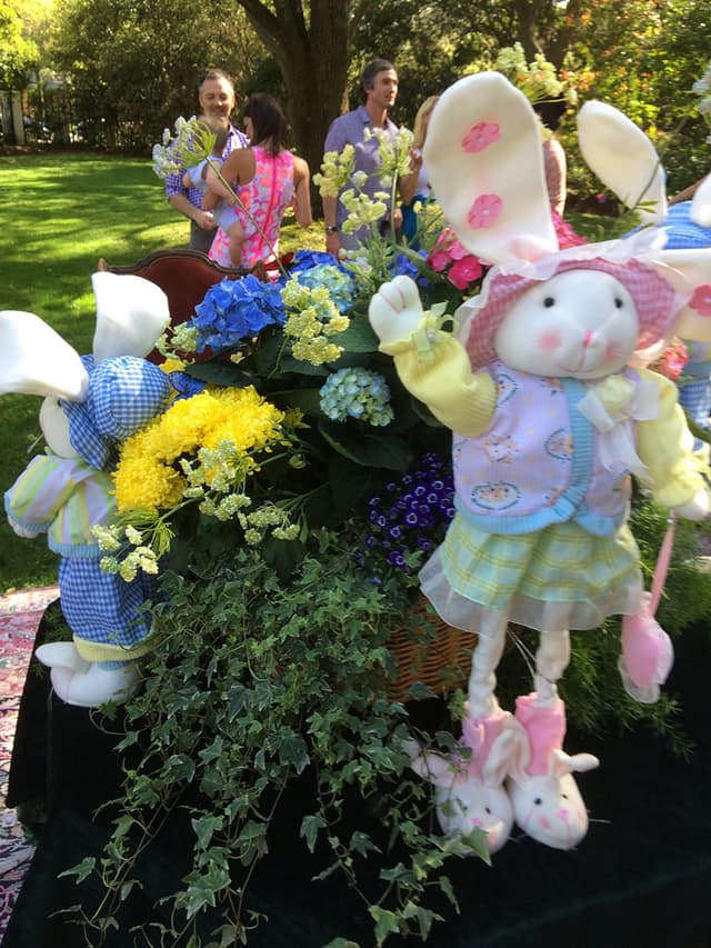 Outdoor Easter party table with spring flowers and bunny accents
