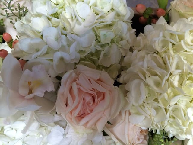 Soft blend of pink and white roses and hydrangeas for a wedding