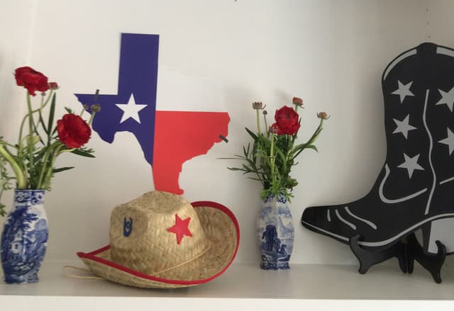 Texas-themed event décor with a straw cowboy hat and lone star state cutout