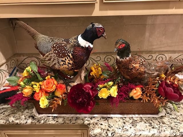 Thanksgiving buffet display with pheasants, roses, and fall blooms