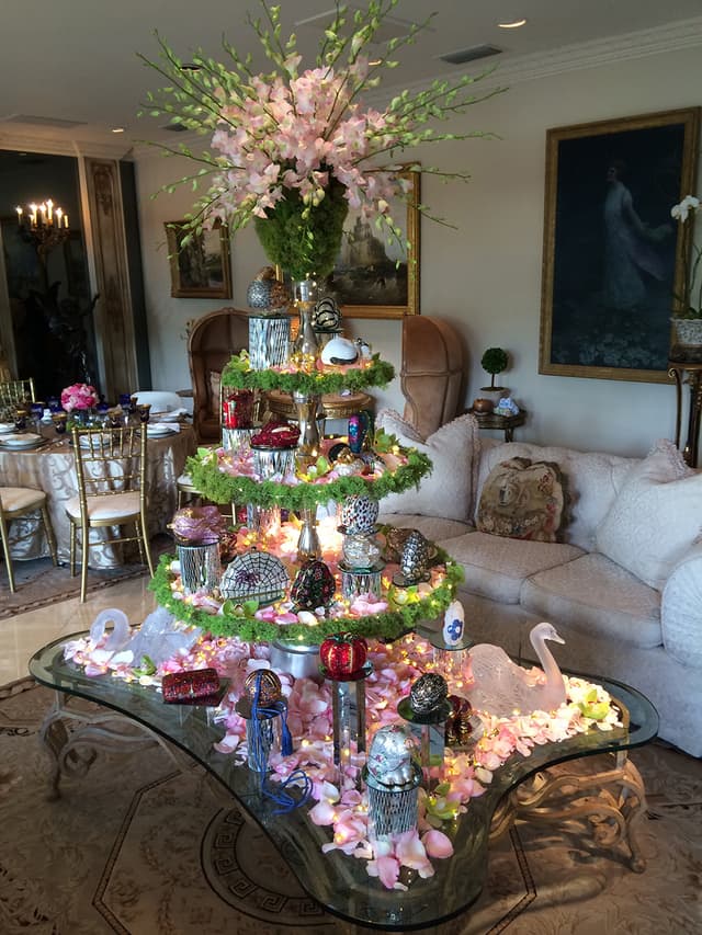 Towering tiered floral display in a living room for a party