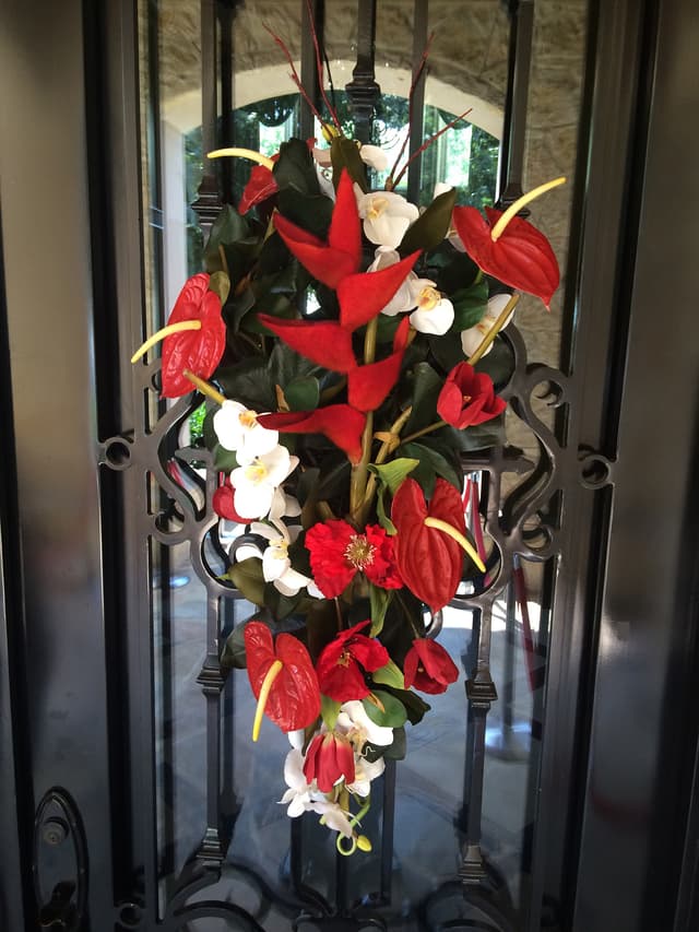 Christmas door swag designed with red anthurium and tropical foliage