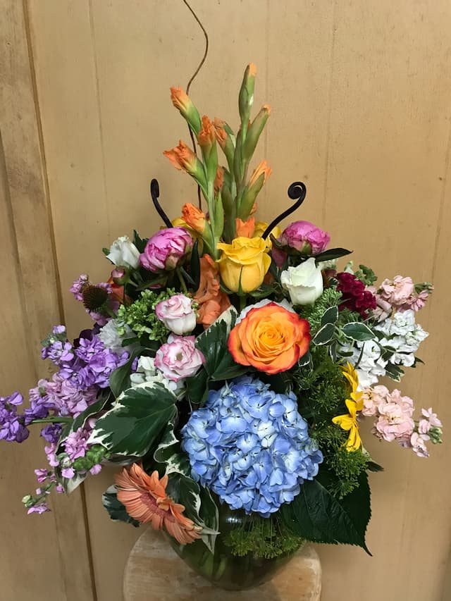 Upscale traditional arrangement with roses, hydrangea, and mixed garden flowers