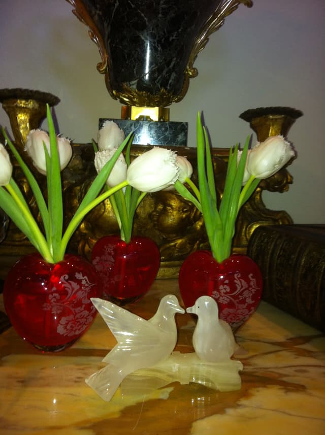 Valentine’s display of white tulips in red glass vases with dove figures
